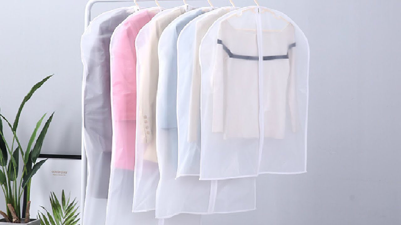 Clothes stored in breathable cotton garment bags for better airflow and odor prevention, showing how to stop clothes smelling musty in wardrobe.