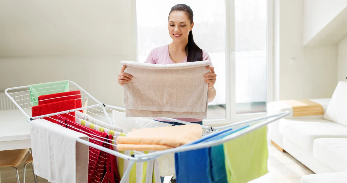 How to Stop Clothes Smelling Musty in Wardrobe by fully drying fresh laundry indoors before storage.