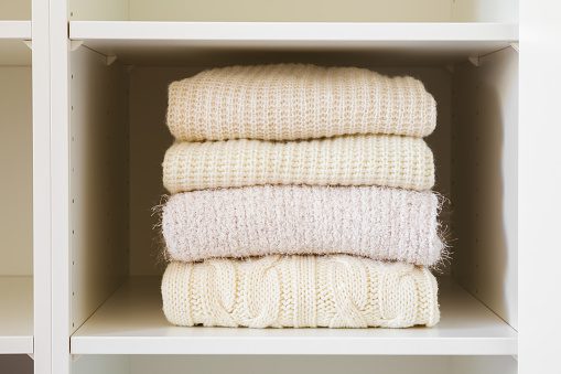 How to store jumpers in wardrobe by the sort of the colour and pattern.