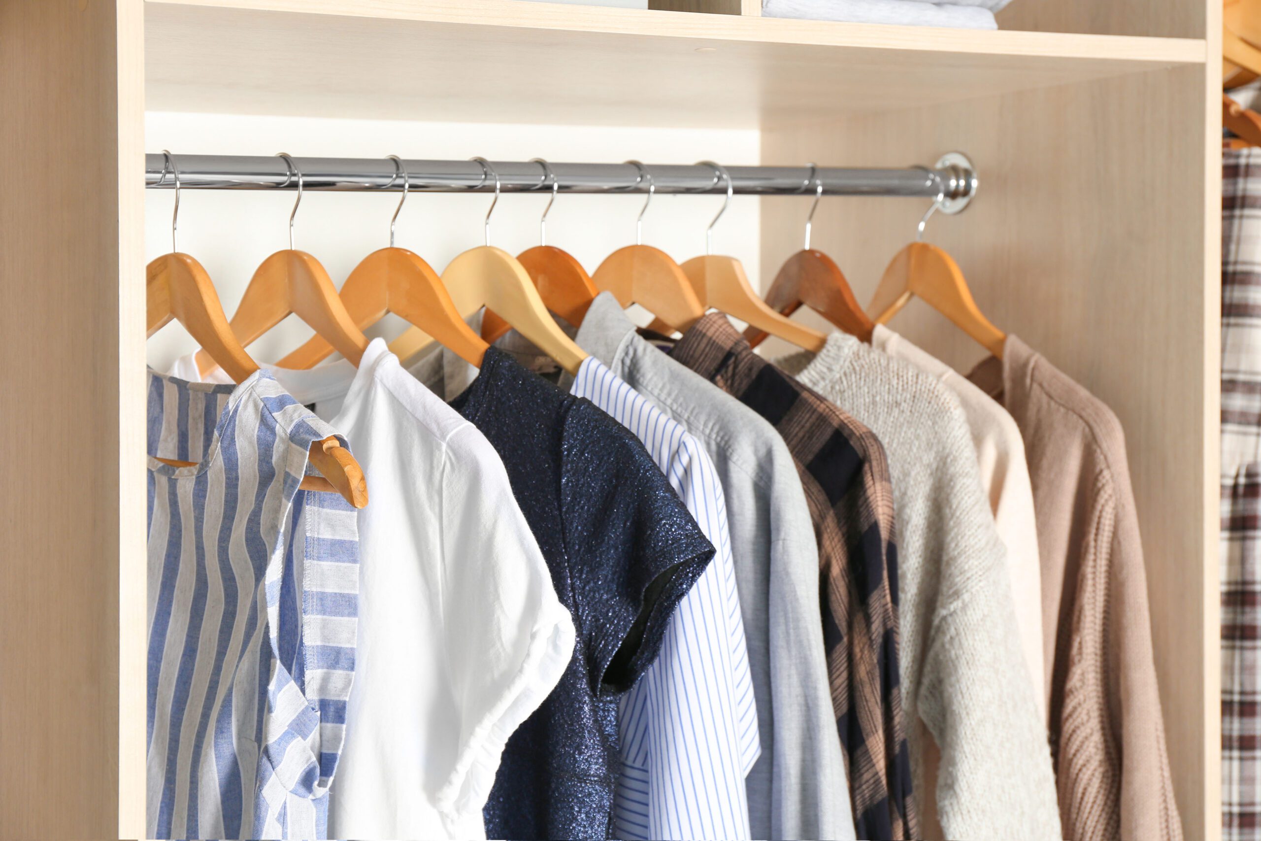 Organised wardrobe setup showing how to stop damp in wardrobe and keep clothes dry.