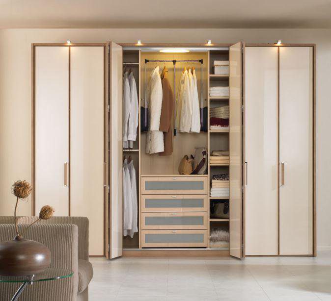 standard wardrobe size triple door wardrobe with multiple storage sections.